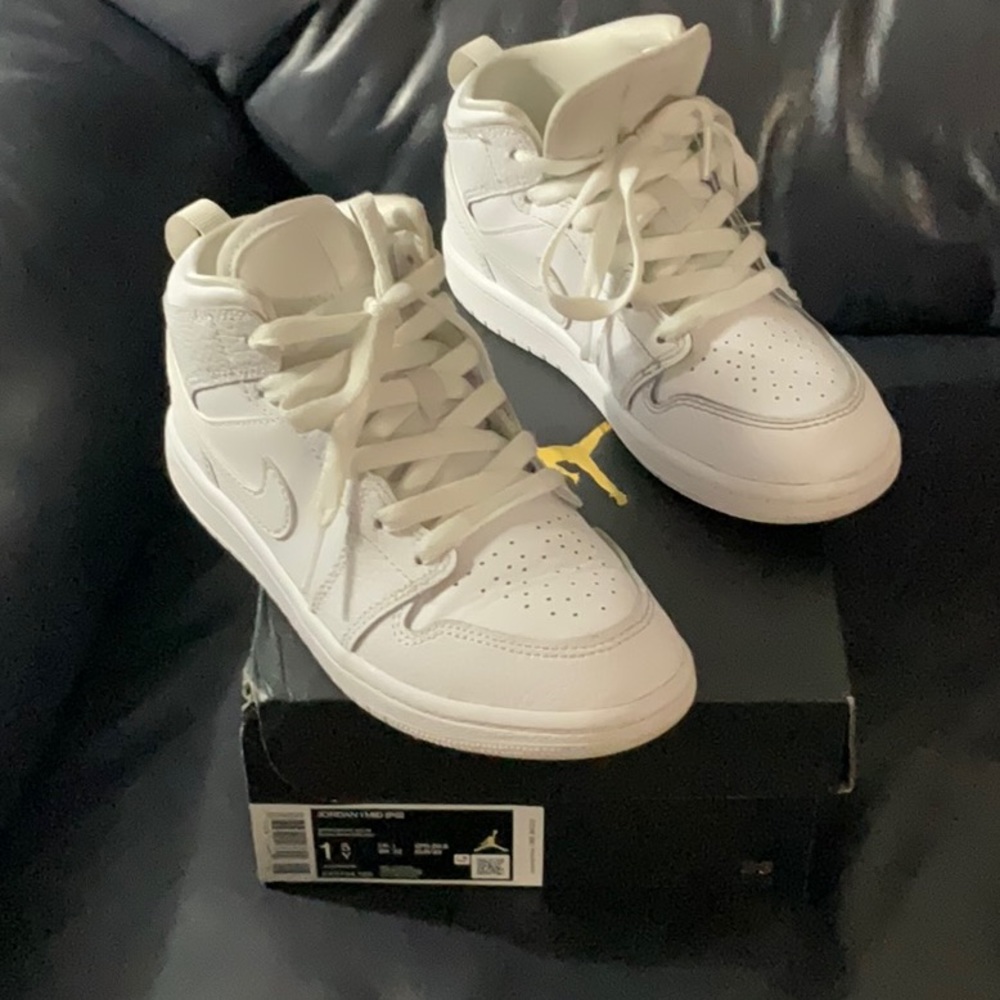 Youth boy Jordan 1 MID all white leather sneaker.
